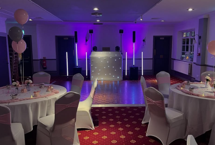 Wedding reception room lit purple, with the ProDJ Portsmouth DJ booth at the far end Wedding reception room lit purple, with the ProDJ Portsmouth DJ booth at the far end