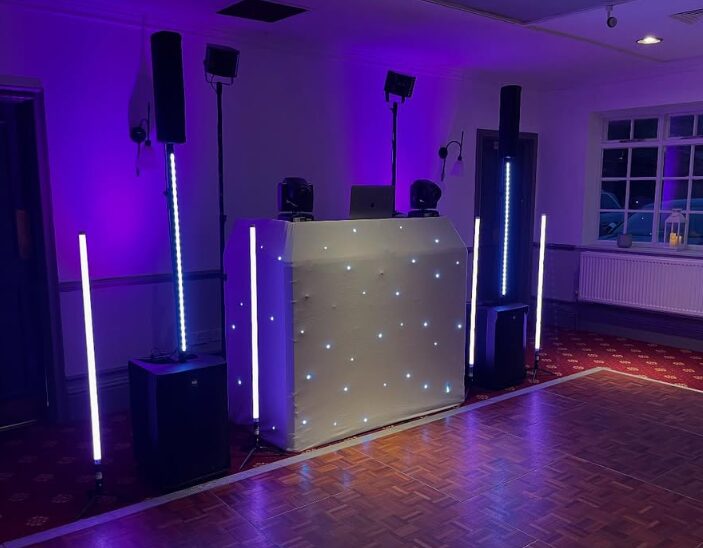 ProDJ Portsmouth DJ booth with a white starlight front and purple uplighting in a function room